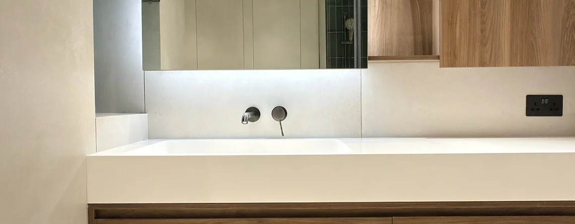 Floating walnut bathroom vanity in Dubai with integrated solid surface basin