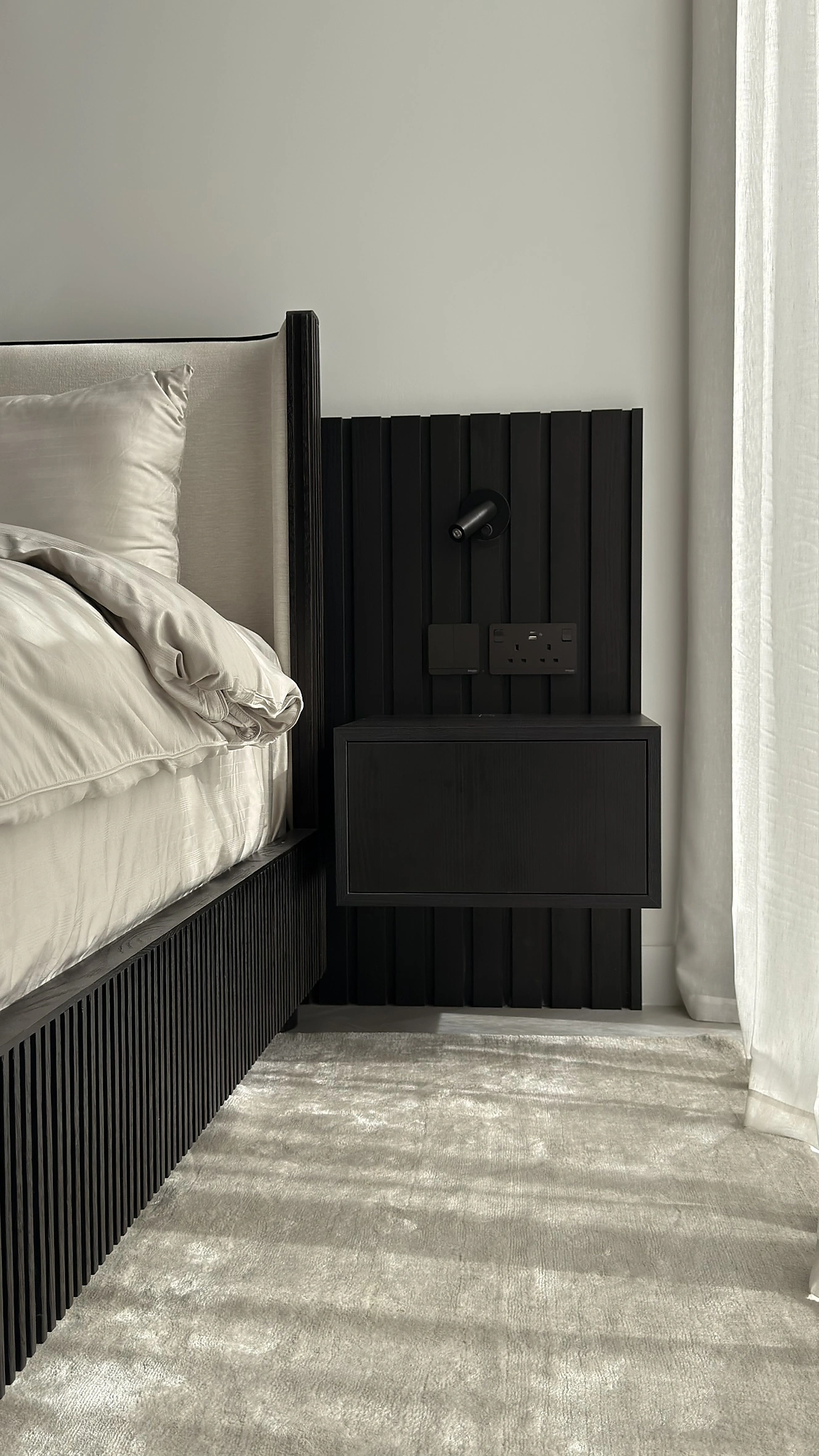 Black fluted bed and floating nightstand in a Dubai villa bedroom fit-out