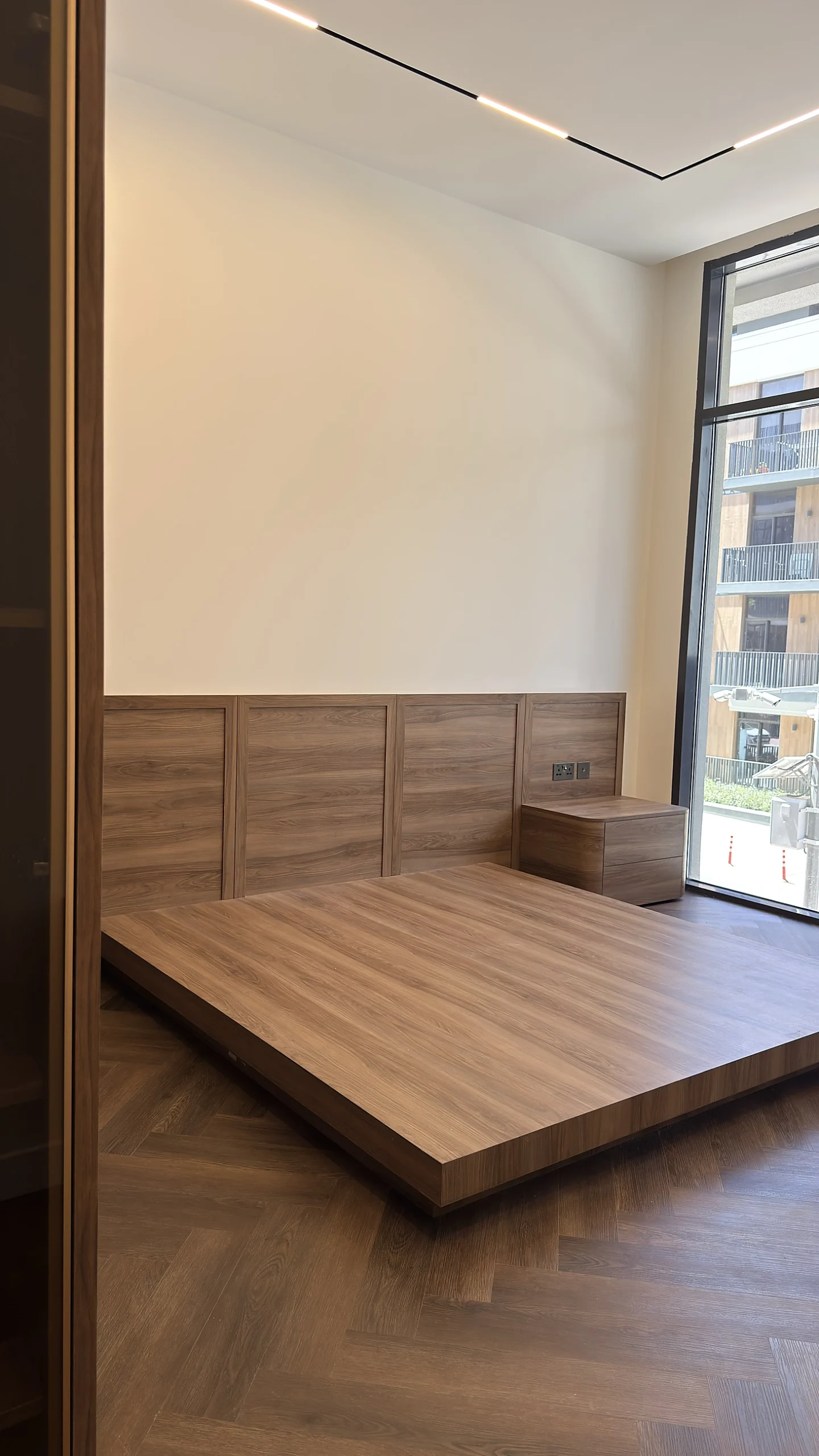 Bedroom fit-out with platform bed and panelled headboard, Dubai
