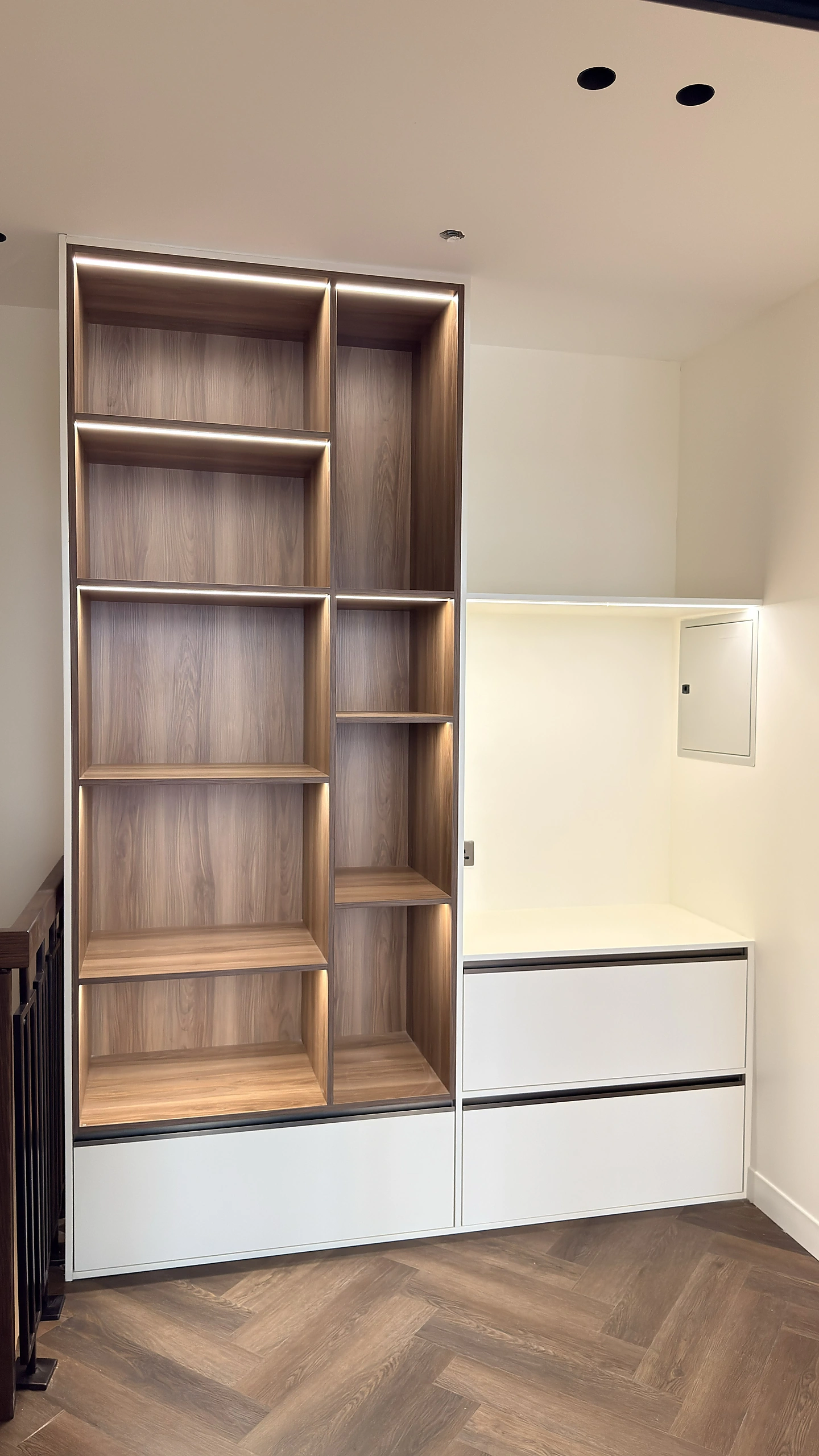 Custom walnut bookshelf unit with LED shelving and drawers, Dubai